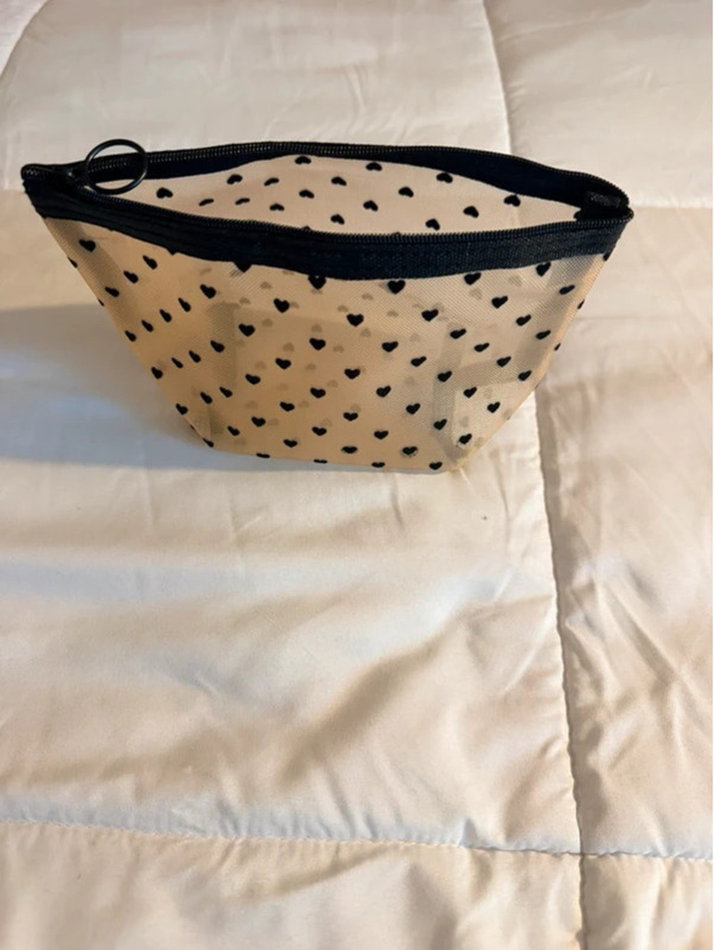 Black heart mesh pouch with black heart pattern on beige
